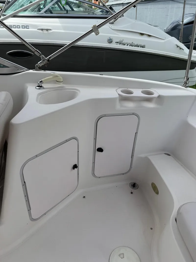 Slide: The Image of 1999 Hurricane 232 FUN DECK boat interior with storage compartments. - 18