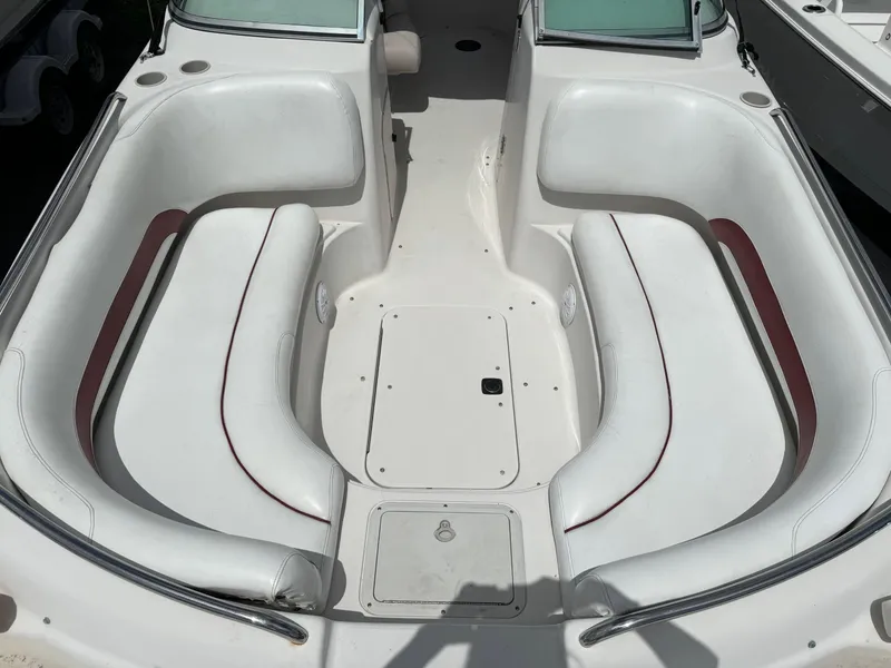 Slide: The Image of 1999 Hurricane 232 FUN DECK boat interior with white seating and red accents. - 20