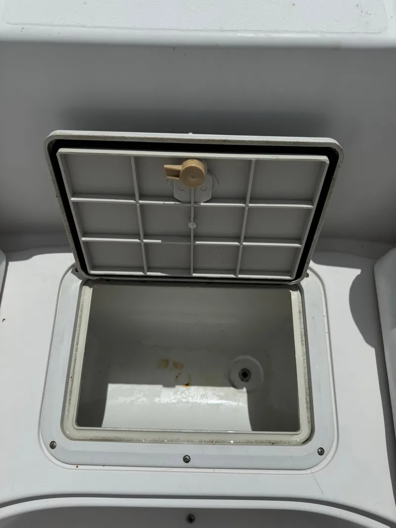 Slide: The Image of Open storage compartment on a 1999 Hurricane 232 FUN DECK boat. - 21