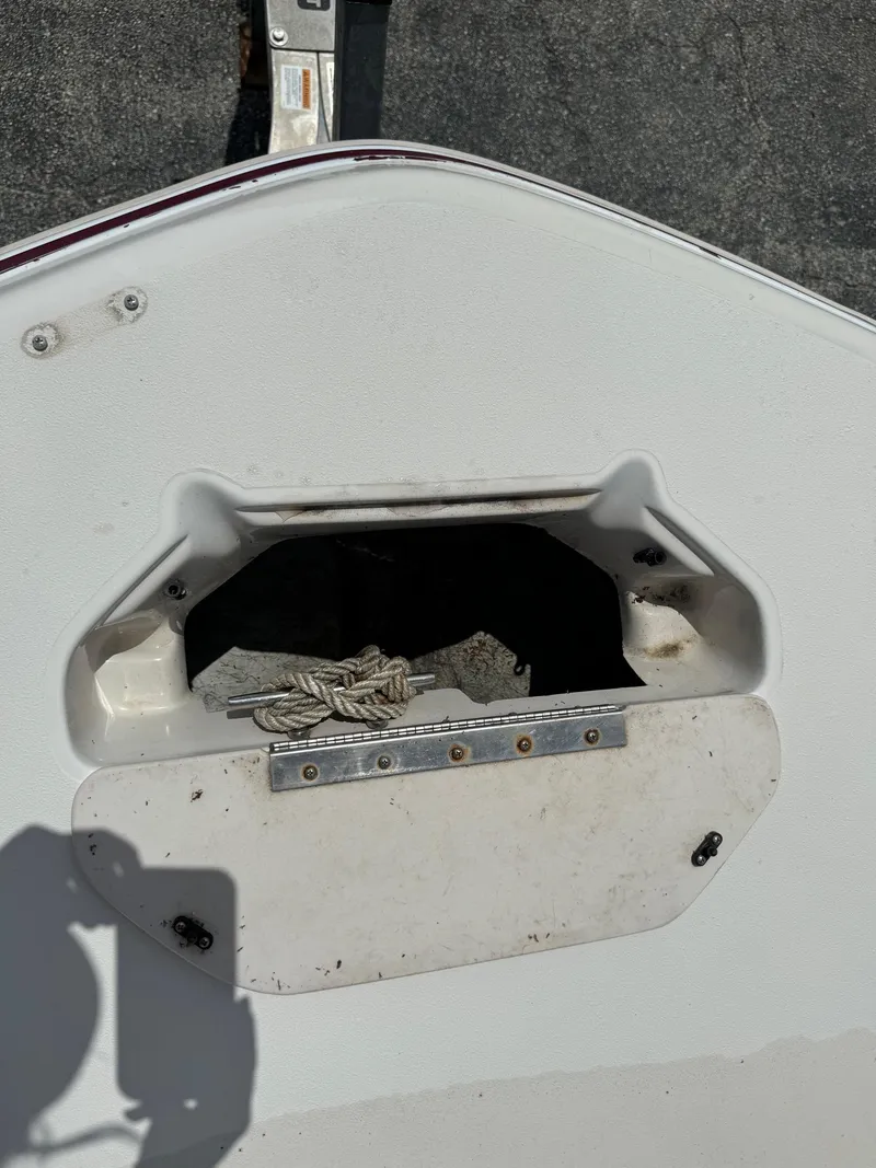 Slide: The Image of 1999 Hurricane 232 FUN DECK boat storage compartment with rope. - 27