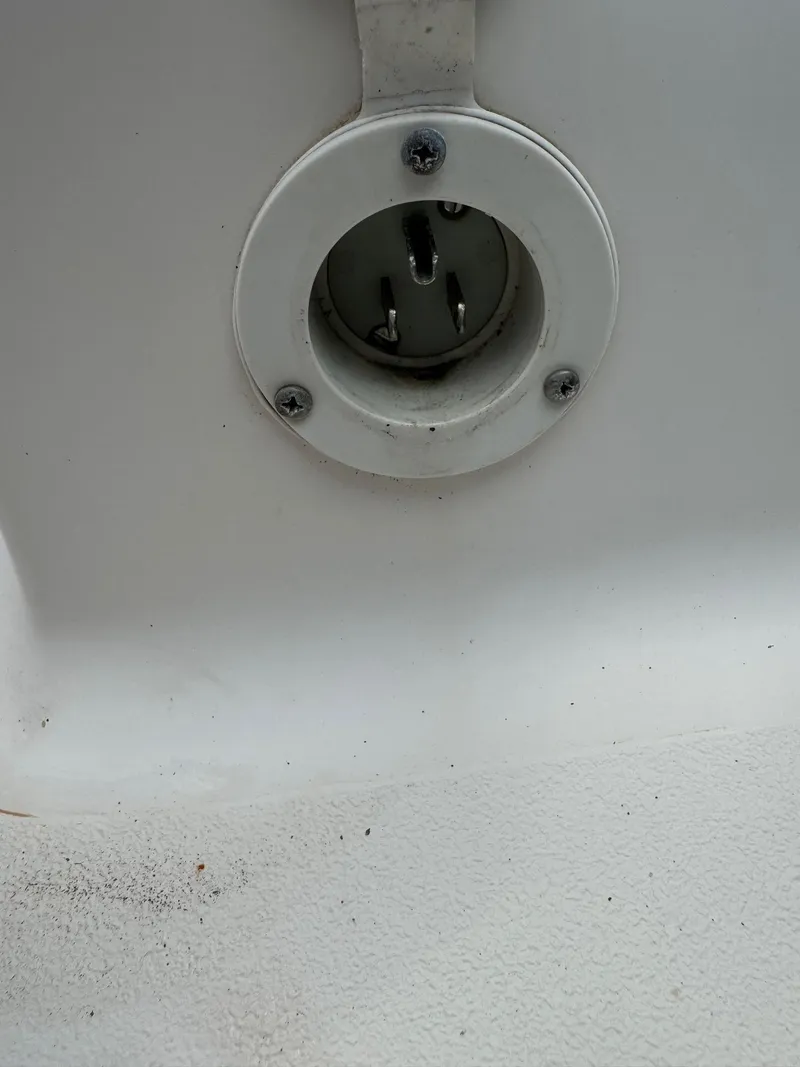 Slide: The Image of Close-up of a 1999 Hurricane 232 FUN DECK boat's electrical socket. - 32