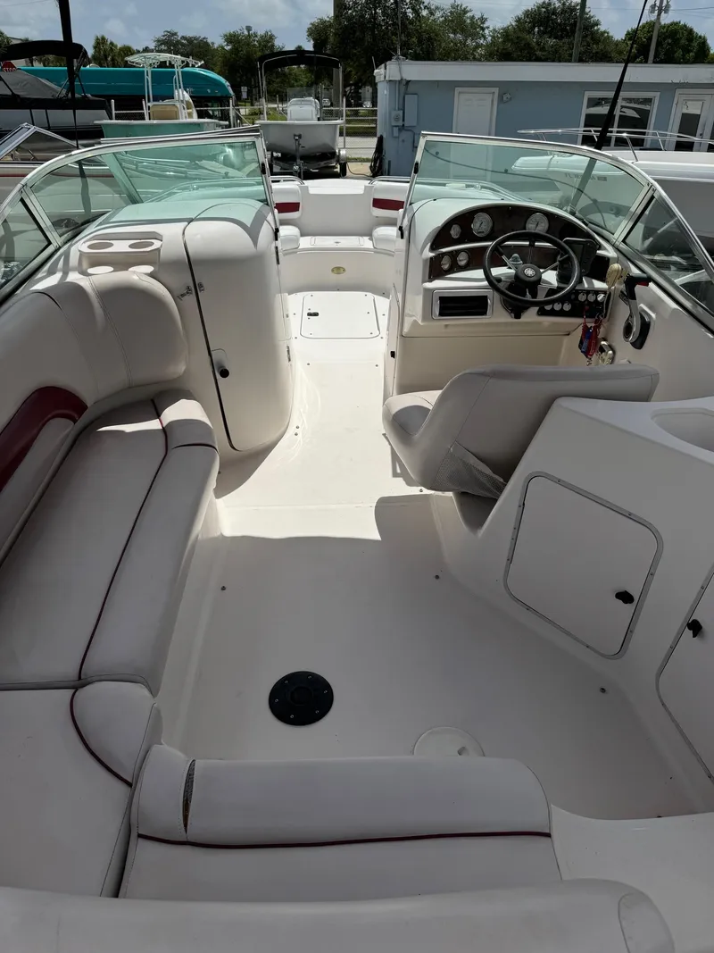 Slide: The Image of 1999 Hurricane 232 FUN DECK boat interior with seating and steering console. - 5