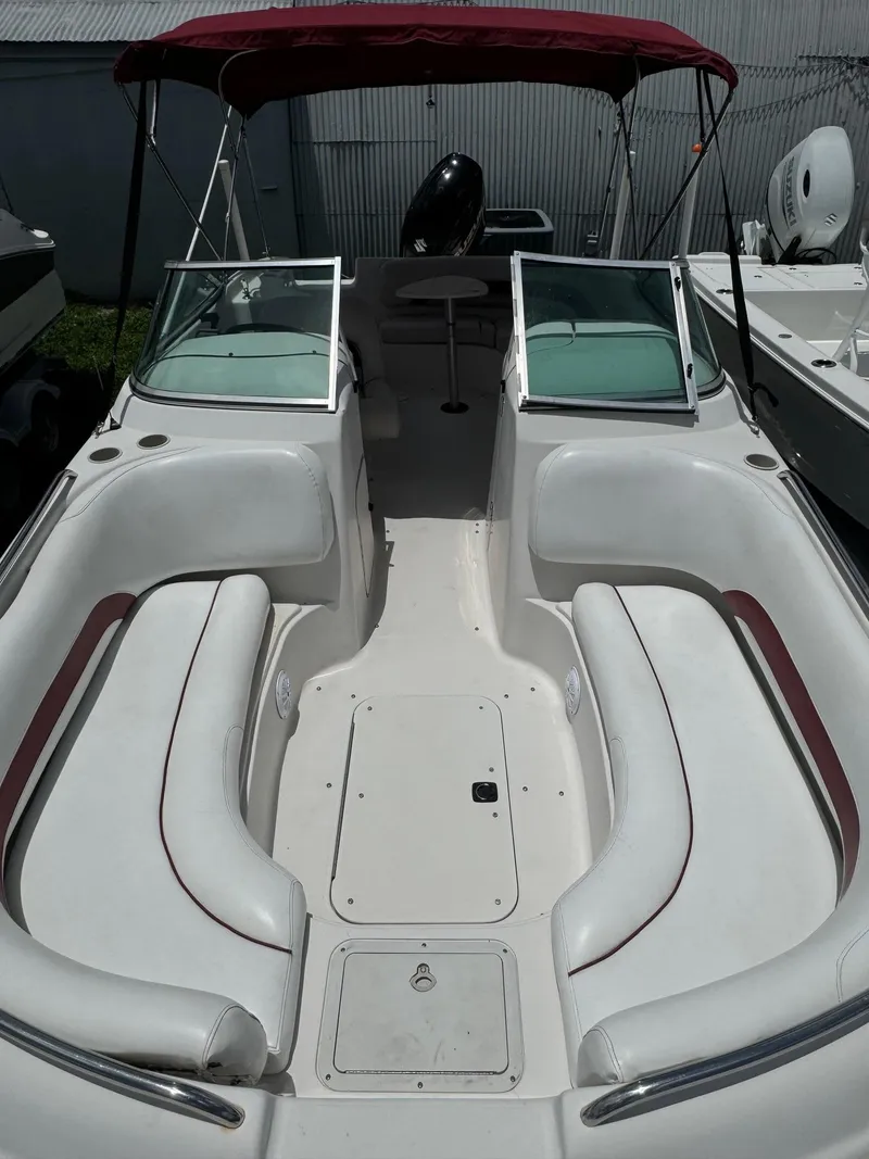 Slide: The Image of 1999 Hurricane 232 FUN DECK boat with red canopy and spacious seating. - 6