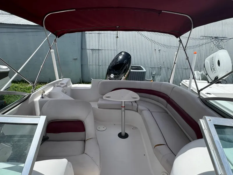 Slide: The Image of 1999 Hurricane 232 Fun Deck boat with red canopy and spacious seating. - 7