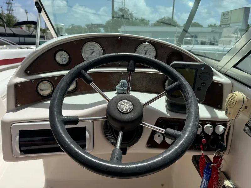 Slide: The Image of 1999 Hurricane 232 Fun Deck boat dashboard with steering wheel and gauges. - 9