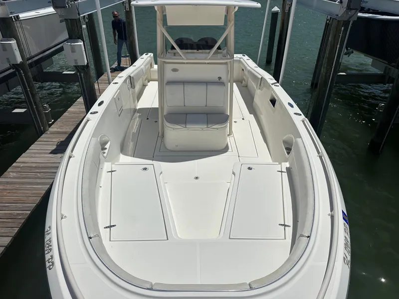 Slide: The Image of 2013 Stamas 317 Tarpon boat docked, showcasing spacious deck and seating area. - 12
