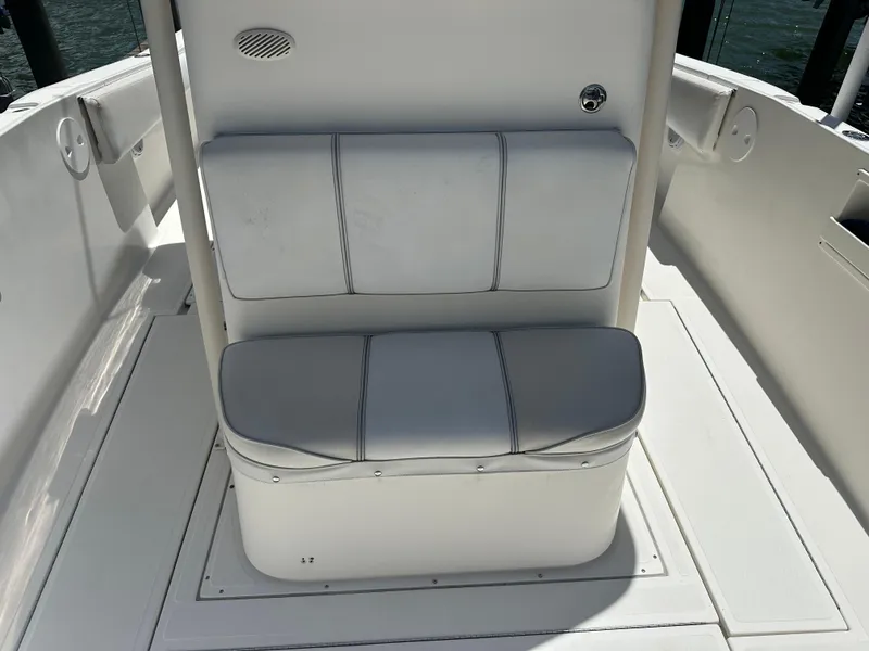 Slide: The Image of 2013 Stamas 317 Tarpon boat seating area with white cushioned bench. - 16