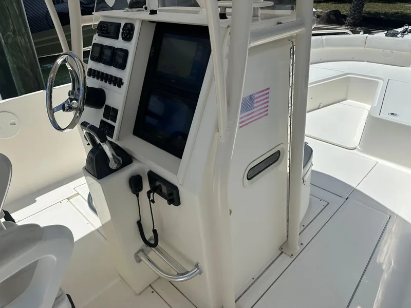 Slide: The Image of 2013 Stamas 317 Tarpon boat console with steering wheel and navigation equipment. - 18