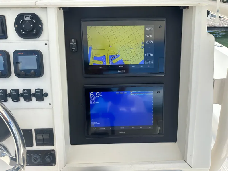 Slide: The Image of Dashboard of a 2013 Stamas 317 Tarpon boat with navigation screens. - 22