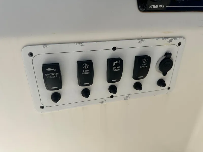 Slide: The Image of Control panel on a 2013 Stamas 317 Tarpon boat with various switches. - 26