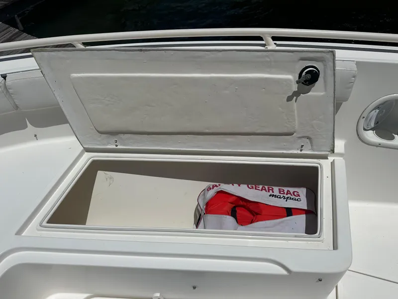 Slide: The Image of Open storage compartment on a 2013 Stamas 317 Tarpon boat with safety gear bag. - 37