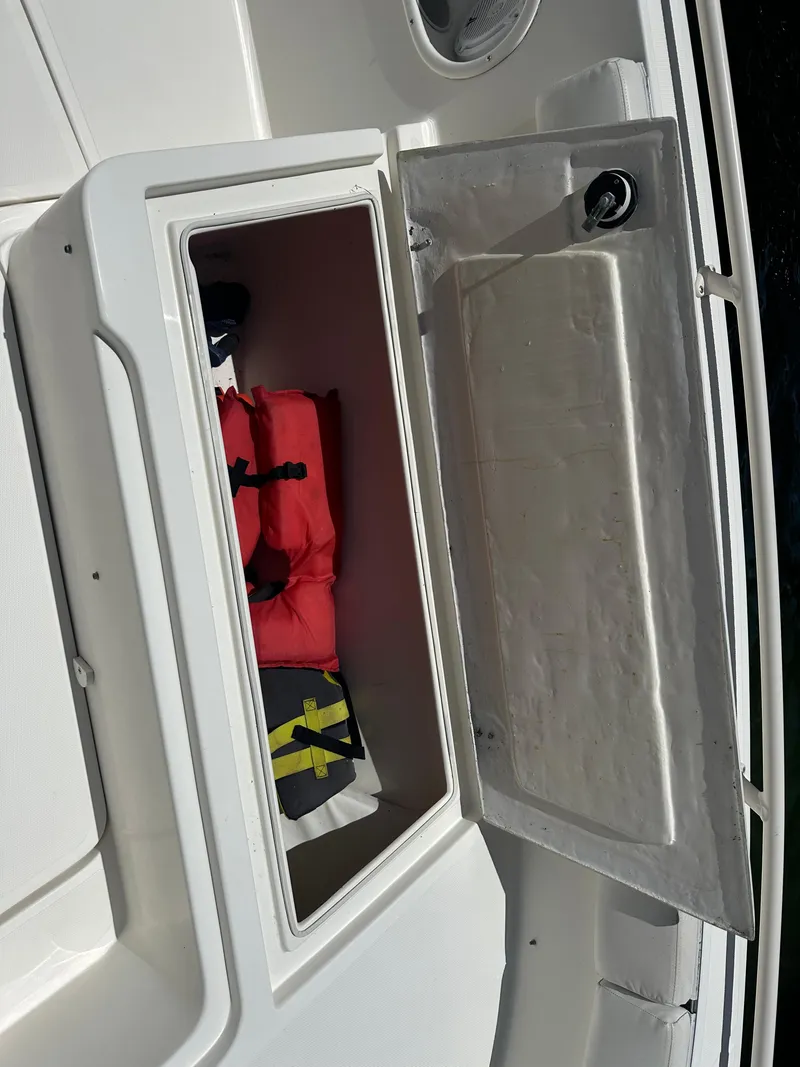 Slide: The Image of Storage compartment on a 2013 Stamas 317 Tarpon boat with life jackets inside. - 41