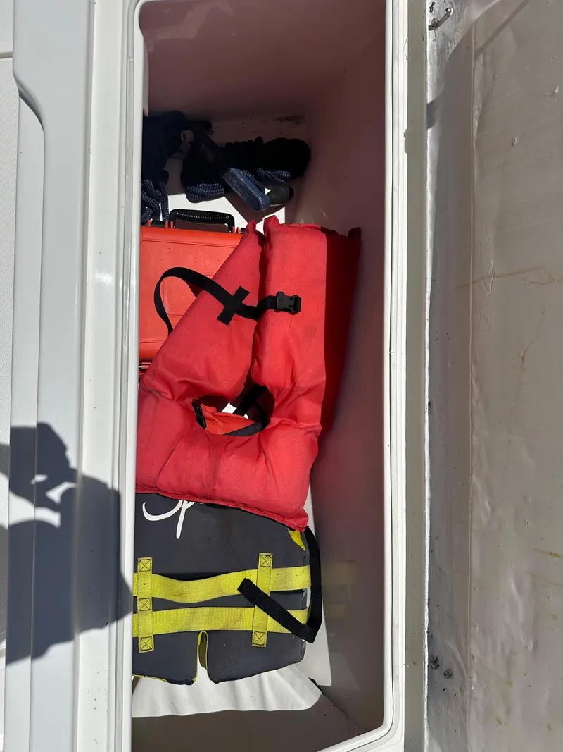 Slide: The Image of Life jackets stored in a 2013 Stamas 317 Tarpon boat compartment. - 42