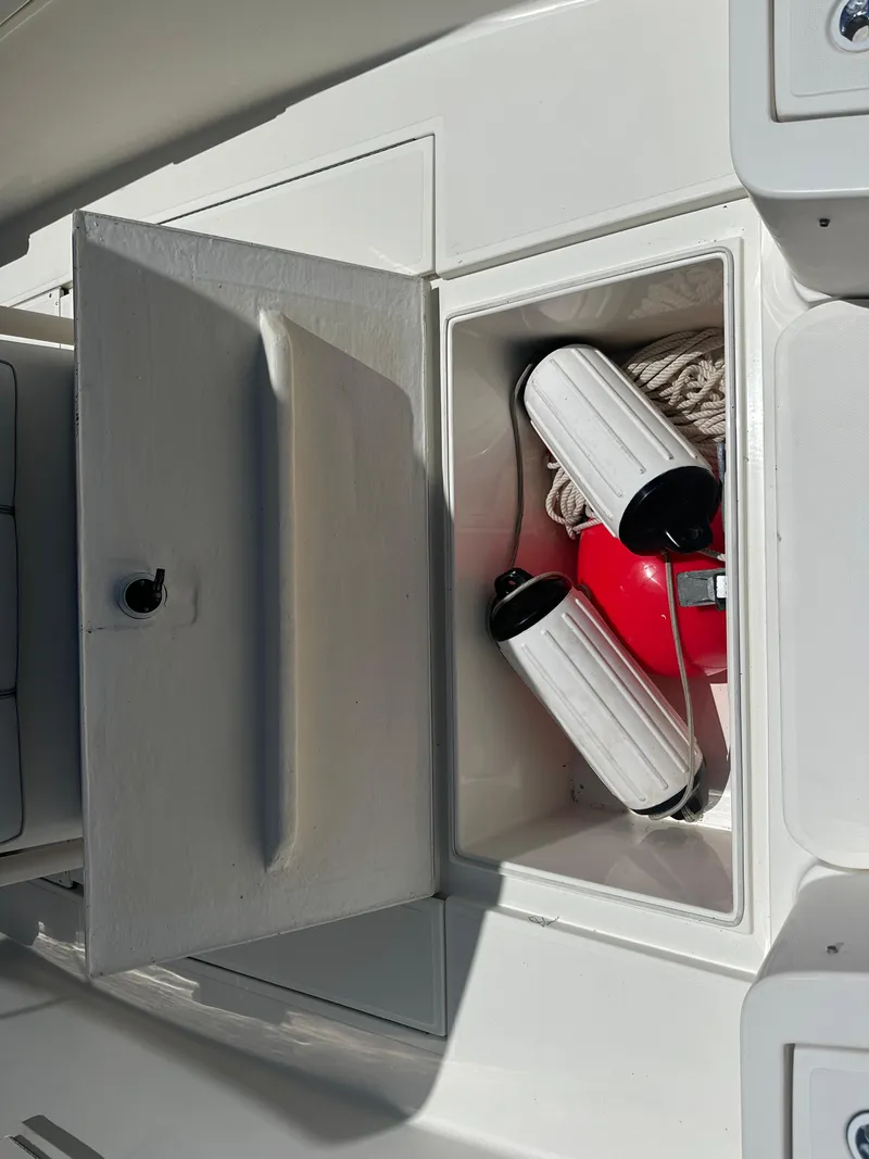 Slide: The Image of Storage compartment on a 2013 Stamas 317 Tarpon boat with safety equipment. - 43