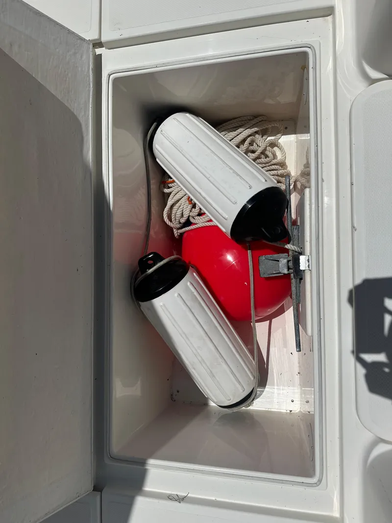 Slide: The Image of Storage compartment on 2013 Stamas 317 Tarpon boat with fenders and buoy. - 44