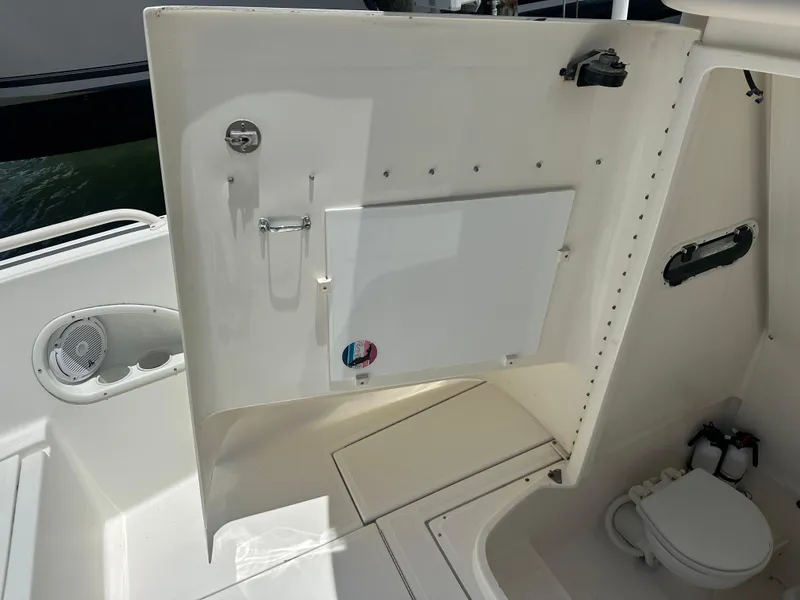 Slide: The Image of 2013 Stamas 317 Tarpon boat interior with open storage compartment and marine toilet. - 46