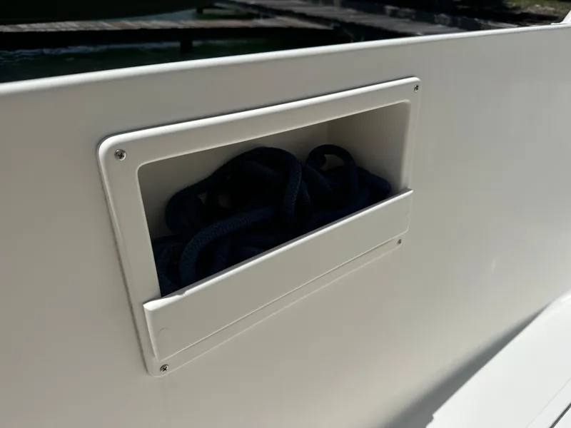 Slide: The Image of Storage compartment on a 2013 Stamas 317 Tarpon boat with coiled rope. - 48