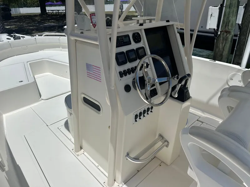 Slide: The Image of 2013 Stamas 317 Tarpon boat console with steering wheel and control panel. - 49