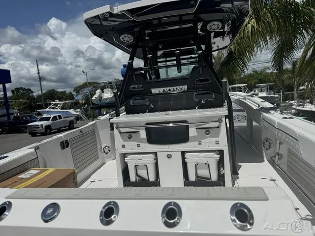 Slide: The Image of 2025 Blackfin 332cc boat with open storage compartments and sink. - 17