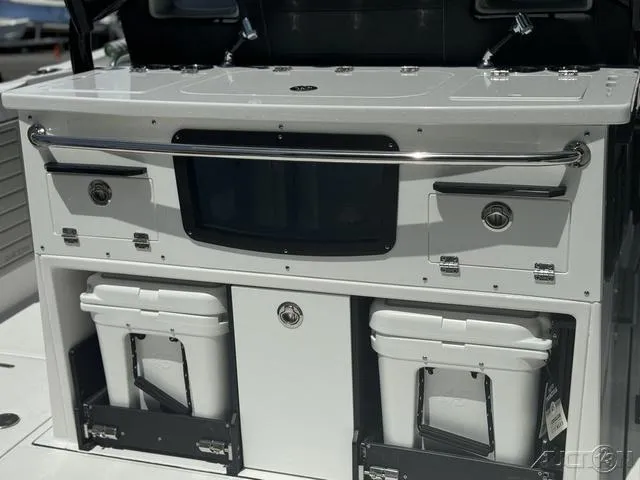 Slide: The Image of 2025 Blackfin 332cc boat interior with rod holders and cup holders. - 19