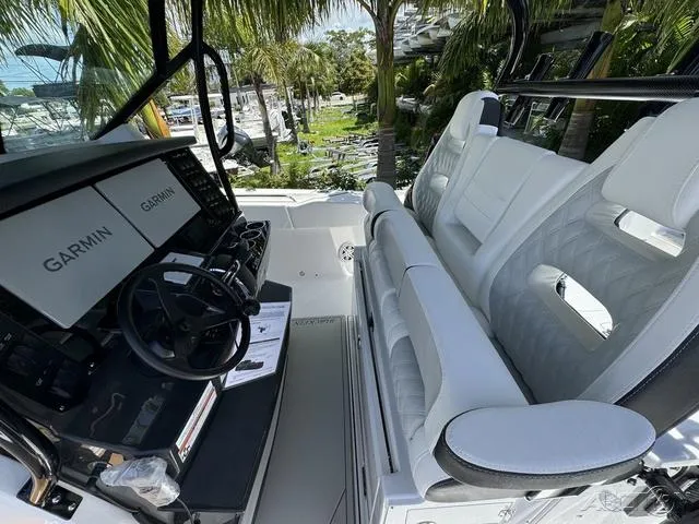 Slide: The Image of 2025 Blackfin 332cc boat interior with cushioned seating and storage compartments. - 32