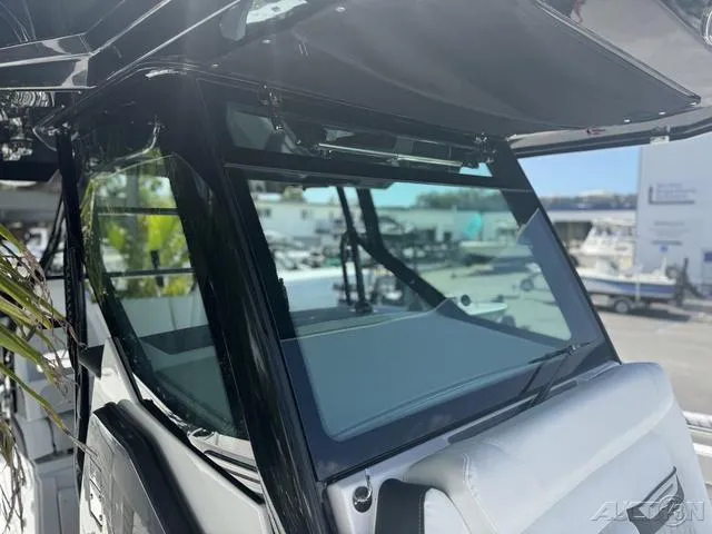Slide: The Image of 2025 Blackfin 332cc boat dashboard with Garmin navigation screens and control panel. - 43