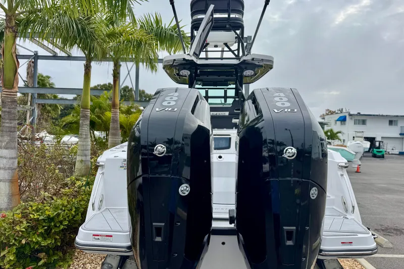 Slide: The Image of 2025 Blackfin 332 CC boat with dual 400 V10 engines, parked near palm trees. - 64
