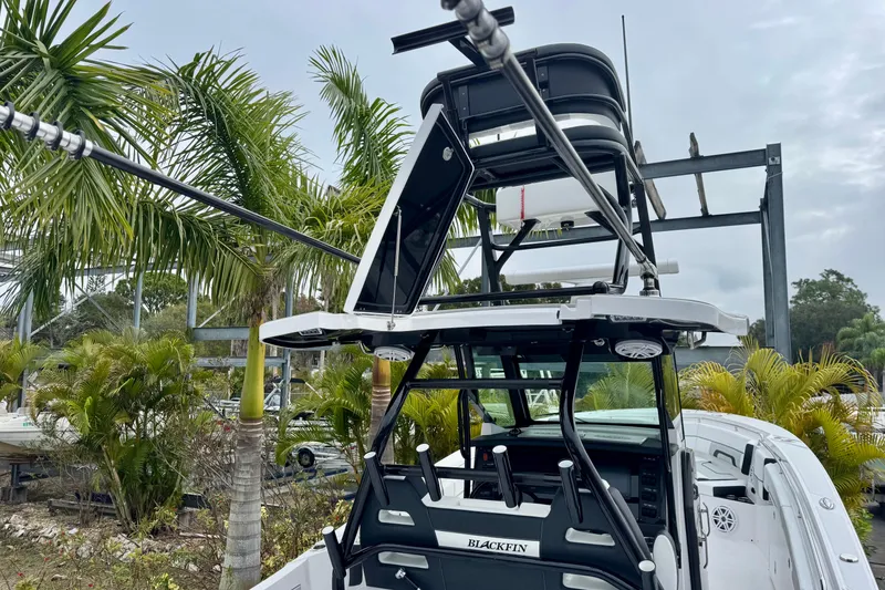 Slide: The Image of 2025 Blackfin 332 CC boat with tower, surrounded by palm trees. - 68