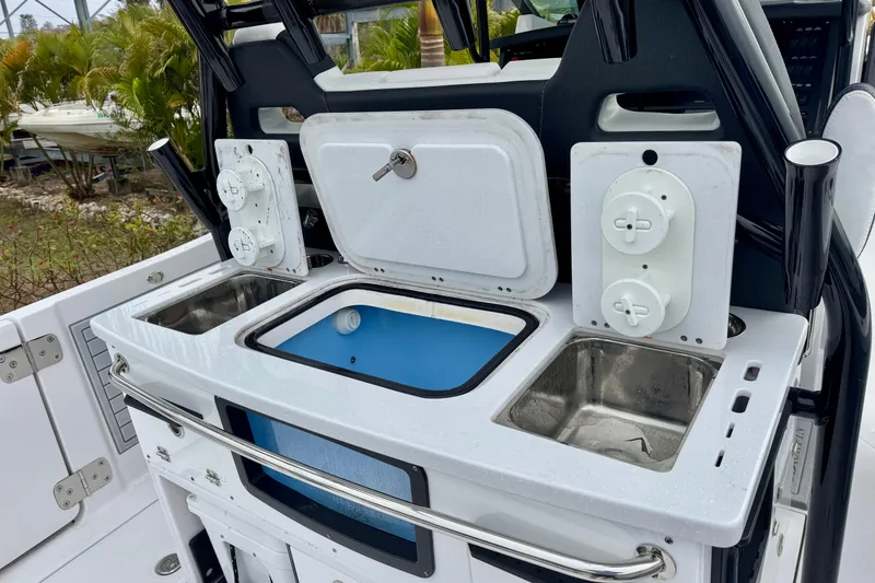 Slide: The Image of 2025 Blackfin 332 CC boat console with sink and storage compartments. - 73