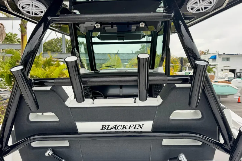 Slide: The Image of 2025 Blackfin 332 CC boat interior with rod holders and sleek design. - 74