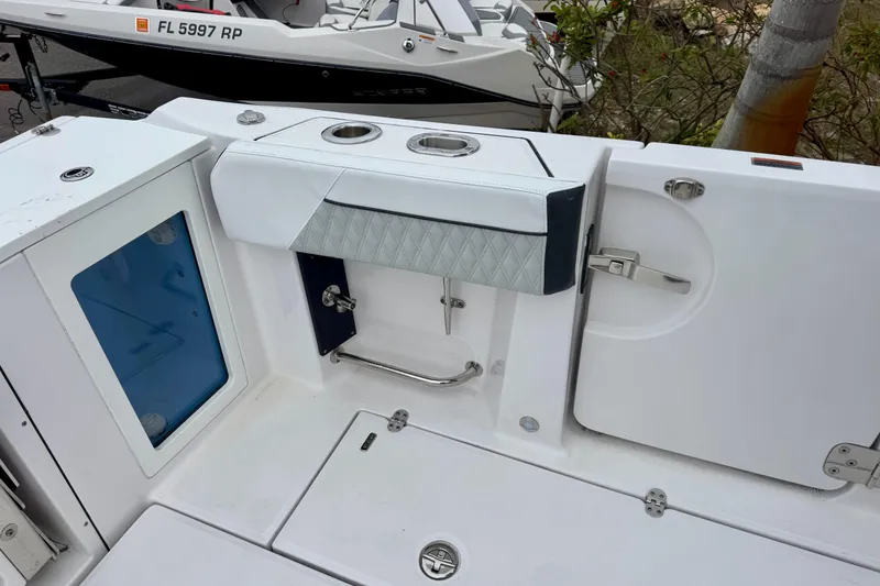 Slide: The Image of 2025 Blackfin 332 CC boat interior with storage compartments and cup holders. - 76