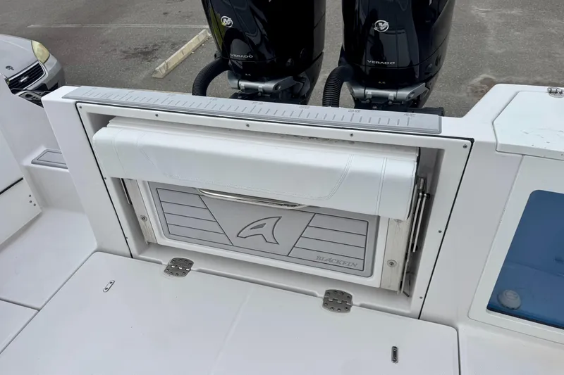 Slide: The Image of 2025 Blackfin 332 CC boat with dual Mercury Verado engines, featuring a foldable seat. - 77