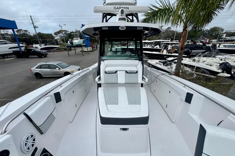 Slide: The Image of 2025 Blackfin 332 CC boat with sleek design, docked in a marina setting. - 82