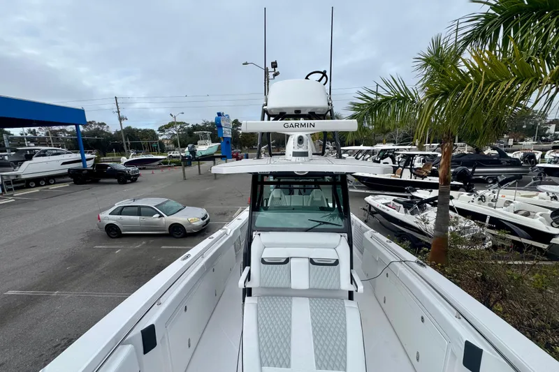 Slide: The Image of 2025 Blackfin 332 CC boat with Garmin equipment in a marina setting. - 83