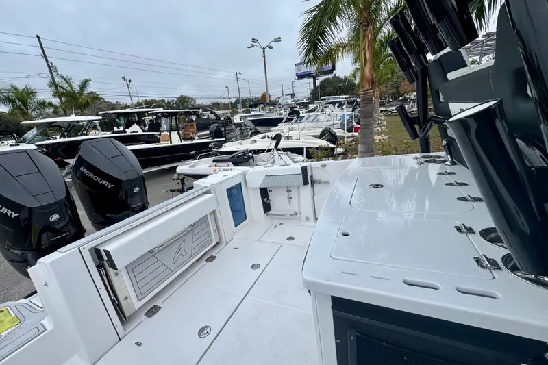 Slide: The Image of 2025 Blackfin 332 CC boat with Mercury engines, docked near palm trees. - 89