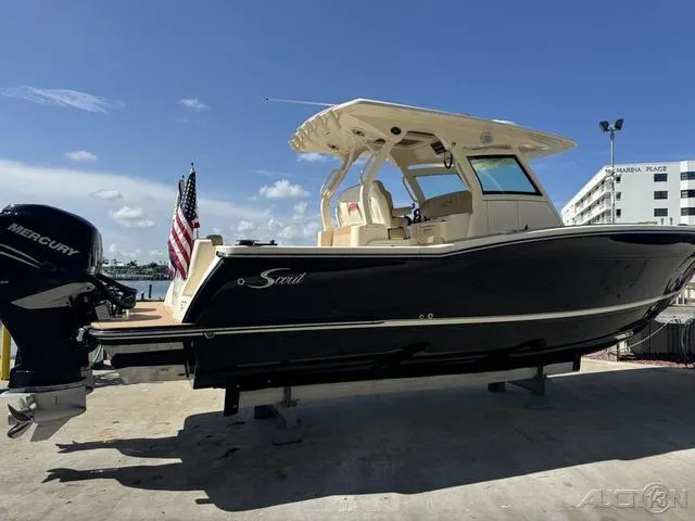 Slide: The Image of 2022 Scout 330 LXF boat with Mercury engines docked at marina. - 10