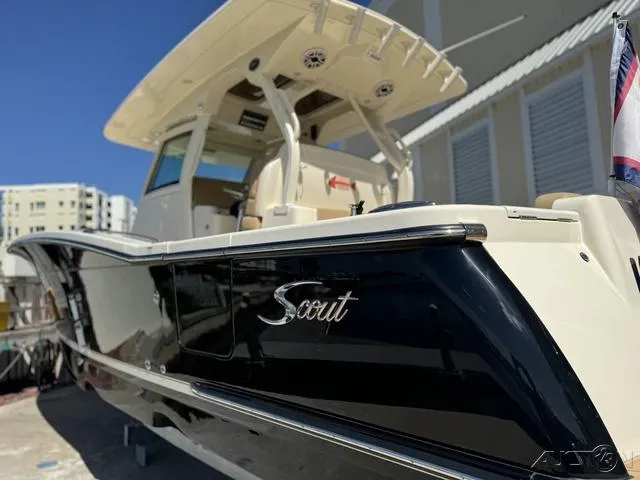 Slide: The Image of 2022 Scout 330 LXF boat with sleek black and white design. - 17
