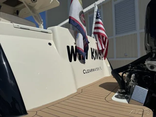 Slide: The Image of 2022 Scout 330 LXF boat stern with flags, Clearwater, FL. - 19