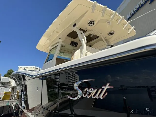Slide: The Image of 2022 Scout 330 LXF boat docked, showcasing sleek design and modern features. - 21