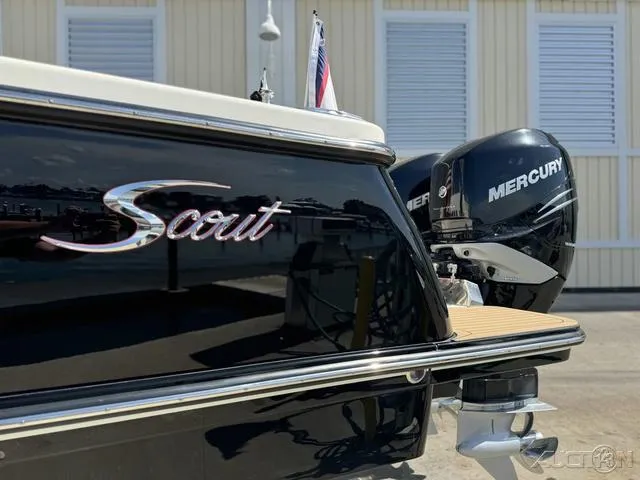 Slide: The Image of 2022 Scout 330 LXF boat with dual Mercury engines docked. - 25