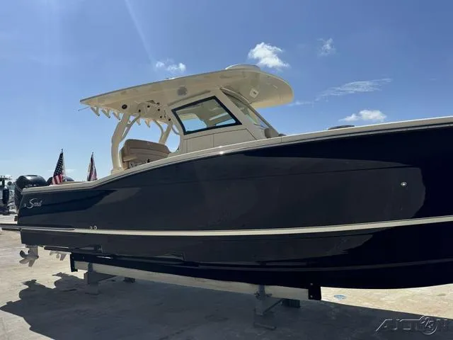 Slide: The Image of 2022 Scout 330 LXF boat on display under clear blue sky. - 29