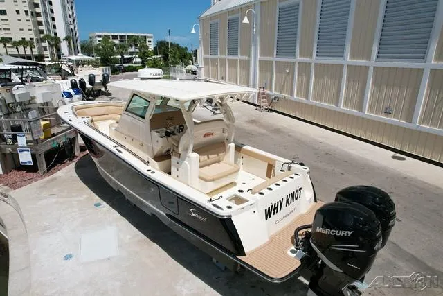 Slide: The Image of 2022 Scout 330 LXF boat with twin Mercury engines docked at marina. - 3
