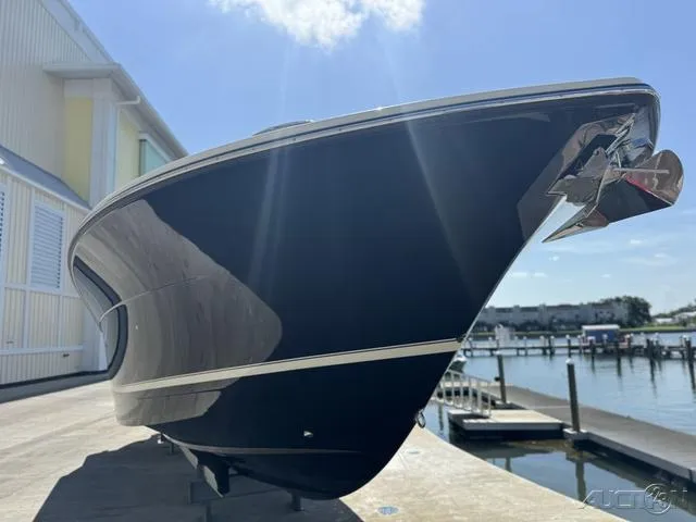 Slide: The Image of 2022 Scout 330 LXF boat docked at a marina under a clear sky. - 31