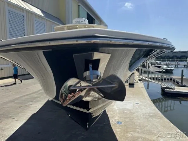 Slide: The Image of 2022 Scout 330 LXF boat docked, front view with propeller and Garmin equipment. - 32
