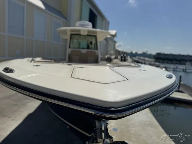 Slide: The Image of 2022 Scout 330 LXF boat docked at a marina, front view. - 33