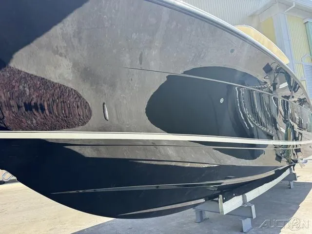 Slide: The Image of 2022 Scout 330 LXF boat with sleek black hull on display. - 35