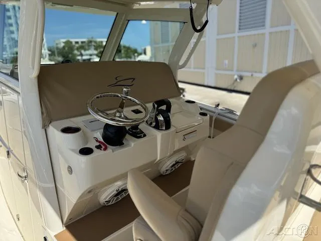 Slide: The Image of 2022 Scout 330 LXF boat cockpit with steering wheel and controls. - 37