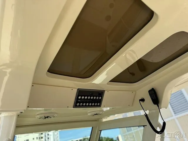 Slide: The Image of 2022 Scout 330 LXF boat interior roof with control panel and radio. - 39