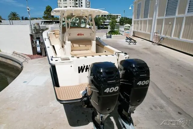 Slide: The Image of 2022 Scout 330 LXF boat with twin 400 Verado engines docked. - 4