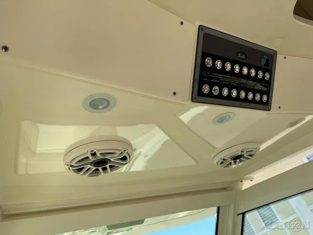 Slide: The Image of 2022 Scout 330 LXF boat interior ceiling with speakers and control panel. - 44